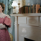 Judy Greer wearing a Victorian-style dress, looking very skeptical.